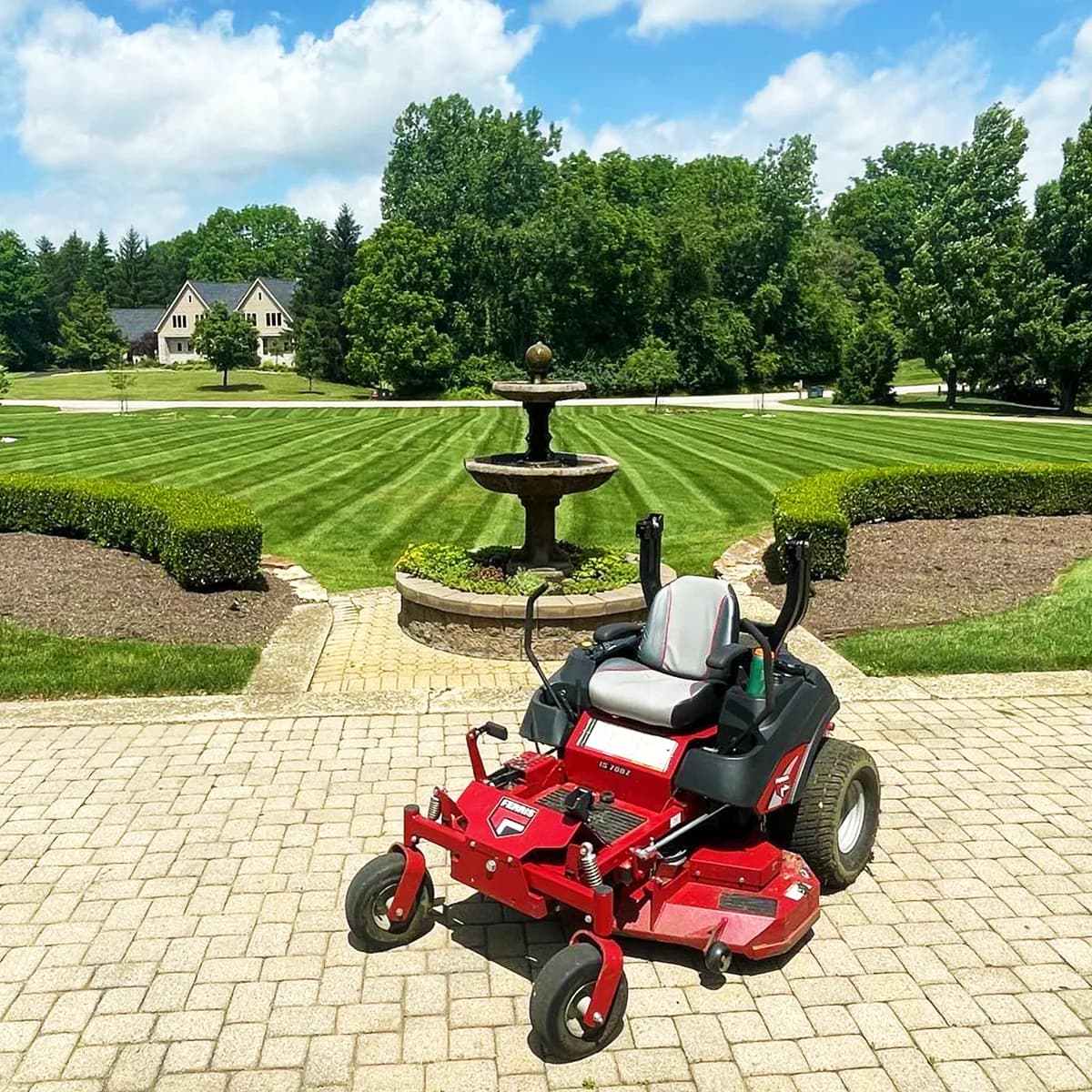Estate lawn with fountain and zero-turn mower